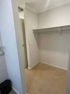 an empty room with a closet and a hallway at Elegant master bedroom with private bathroom in Point Cook
