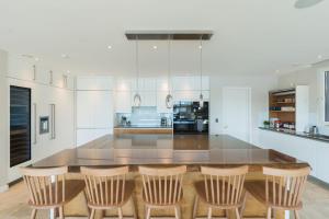 a kitchen with a table and four chairs at 10 Bowmoor Edge By Birch Stays 