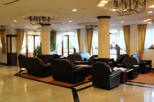 a waiting room with chairs and tables and windows at Helena Park - Ultra All Inclusive in Sunny Beach