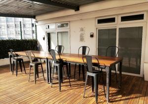 a large wooden table and chairs on a deck at Apto moderno zona 1 in Guatemala