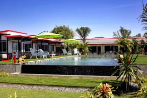 a swimming pool in front of a house at Cape Go Resort in Chao Lao Beach