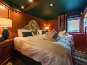 a bedroom with a bed with towels on it at Three Peaks Barn in Carnforth