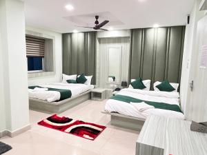 a bedroom with two beds with green and white at Hotel Sohrai Inn in Rānchī