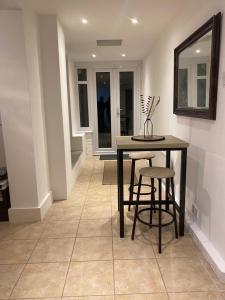 a dining room with a table and two stools at Comfort at its best! in Gillingham