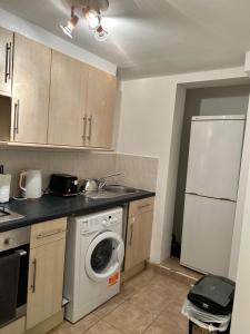 a kitchen with a washing machine and a washer at Comfort at its best! in Gillingham