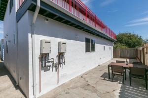 a patio with a table and a building with a table and chairs at Newly Remodeled Cozy 2BR or 3BR Apartment in Tanforan, block away from CalTrain, near SFO in San Bruno