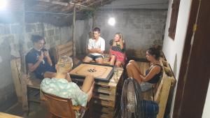 a group of people sitting around a table playing a game at Anosha Villa in Weligama +15 photos
