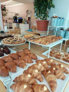 a display of breads and pastries on tables in a store at Hotel Astor in Lido di Classe