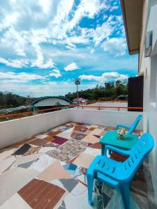 a blue chair sitting on top of a roof at Juanito's Resort in Tangalan