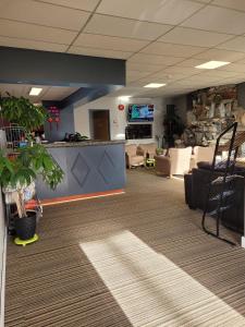 an office lobby with a waiting area with a desk at Valemount Vacation Inn in Valemount