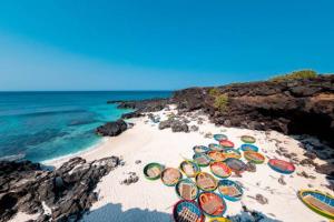 a beach with a bunch of umbrellas on the sand at Ly Tri Ly Son Hotel in Ly Son