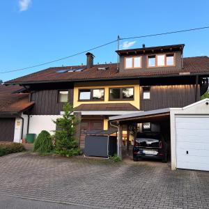 a house with a car parked in the garage at Hirsch Glück in Ofterschwang