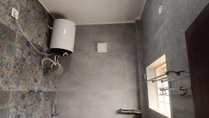a bathroom with a light on the wall at Lavish inn homestay in Mysore