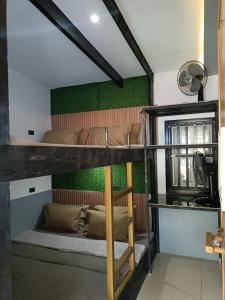 a bunk bed in a room with a green wall at Holyghost Veranda Baguio Transient Guest House 42 step rooftop in Baguio