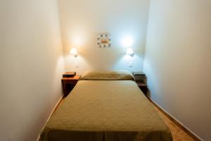 Kleines Zimmer mit 2 Betten und 2 Leuchten in der Unterkunft HOTEL TROPICAL IGUAZU in Puerto Iguazú