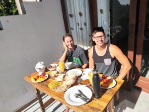 two people sitting at a table with food on it at Rock Paradise Homestay in Ella +64 photos