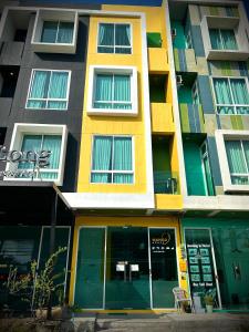 an apartment building with a yellow at Studio room in Mango House in Phuket