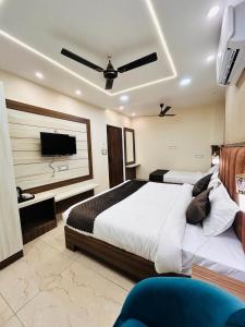 a bedroom with a bed and a flat screen tv at Monga Dream Residency - 5 MINUTES WALK FROM GOLDEN TEMPLE in Amritsar