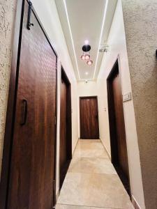 a hallway with two wooden doors and a hallway with a hallway at Monga Dream Residency - 5 MINUTES WALK FROM GOLDEN TEMPLE in Amritsar