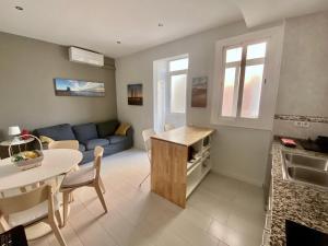 a kitchen and living room with a couch and a table at Barcelona Family Beach in Barcelona