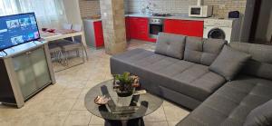 a living room with a couch and a table at Library Apartment by Bohem Rentals in Durrës +26 photos