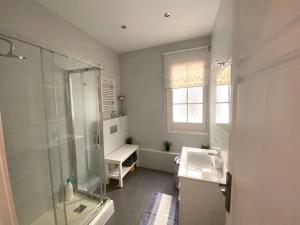 a white bathroom with a sink and a shower at Barcelona Family Beach in Barcelona