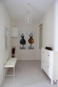 a white room with a dresser and a chandelier at Barcelona Family Beach in Barcelona