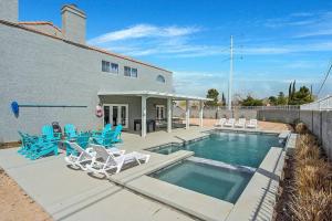 a swimming pool with blue chairs and a house at Grand Casa 7 Bdr/4 Ba 15 Beds Sleeps up to 24 in Las Vegas