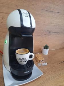 a coffee maker is making a cup of coffee at Studio - Cozy Home Slatina in Slatina