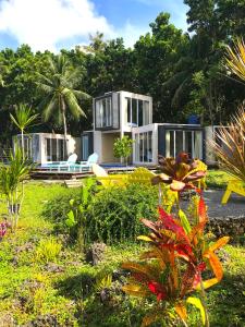 a house in the middle of a garden with plants at The LivingSpace Villa in Camotes Islands