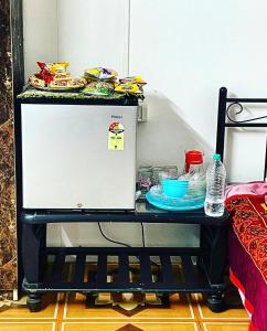 a small table with food on top of it at Bougain Villa- Sinhgad fort -Bedroom- Garden- Kitchen- AC- Wi-Fi-Parking-Khadakwasala Pune in Kharakvasla