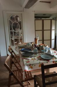 a dining room table with plates and dishes on it at B&B Monte Donato in Bologna
