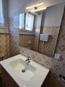 a bathroom with a sink and a mirror at Appartamenti Mulàr in Andalo +75 photos