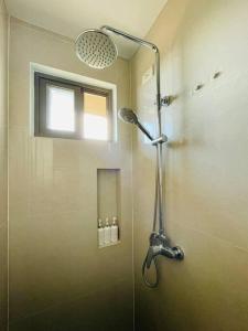 a shower with a glass door in a bathroom at * * WV 1 Minimalist Studio in Iloilo City +2 photos