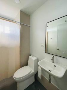 a bathroom with a white toilet and a sink at * * WV 1 Minimalist Studio in Iloilo City