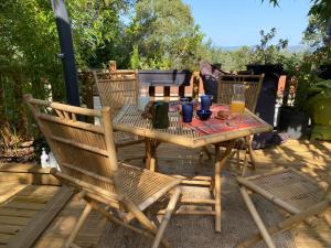 a wooden table and chairs on a patio at Saint tropez-Gassin Bungalow LUXE 6 personnes in Gassin