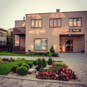 a large house with a garden in front of it at Villa Vanilla in Sigulda