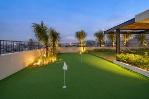 un campo de minigolf en una casa con palmeras en Thè HEM Hotel and Apartment, en Da Nang