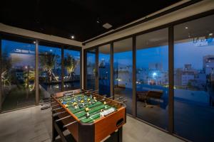 a pool table in a room with a view of the city at Thè HEM Hotel and Apartment in Da Nang