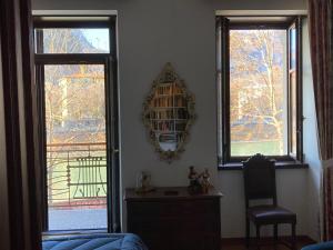 - un salon avec deux fenêtres et un miroir dans l'établissement Casa Daniela, à Trente
