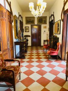 a living room with a checkered floor and chairs at Casa Daniela in Trento