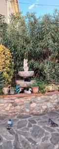 a stone fountain in a garden with plants at Hébergements à La Rive, Accueil ouvert tous les jours jusqu'à 20h00 dernier délai, depuis 30 ans ! Réserver ici svp ! Merci ! Aucun règlement à distance accepté, Paiement par CB, Espèces, Chèque ou Chèques-Vacances impérativement à la remise des clefs ! in Amélie-les-Bains-Palalda +272 photos