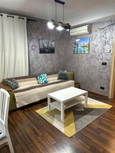 a living room with a couch and a table at Paulina Apartament in Timişoara