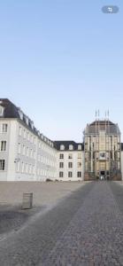 a large white building with a street in front of it at In Saarbrücken Stadtnahe gemütliche Wohnung am Deutsch-Französischen Garten in Saarbrücken