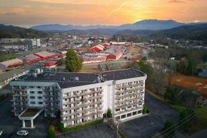 an aerial view of a building with mountains in the background at Park Tower Inn in Pigeon Forge