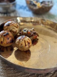 drie muffins op een bord op een tafel bij Snow Biscuit Villa in Dharamshala