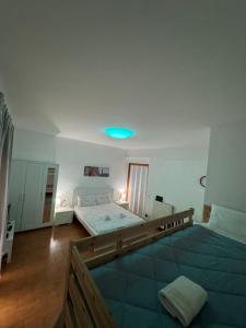 a bedroom with two beds and a blue light at Guest House Demma in Rome