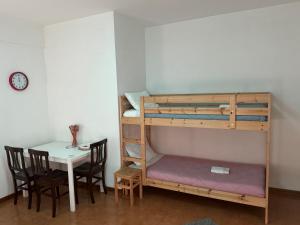 a room with a bunk bed and a table at Guest House Demma in Rome