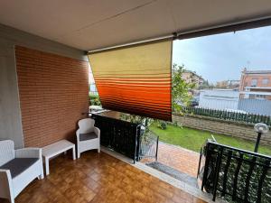 a balcony with two chairs and a large window at Guest House Demma in Rome