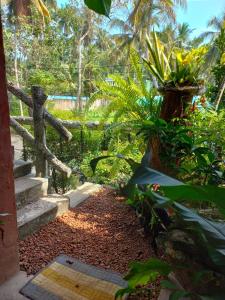 a garden with stairs and plants and a fence at SD3M ART GALLERY Villa in Dickwella